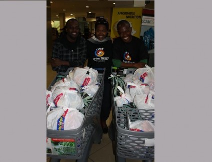 Afrika Tikkun's Trevor Molefe, Nomagugu Moyo and Montlha Kwenaite with the collected food items.