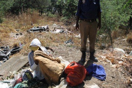 Leaving his home… A man packs up his belongings from the man-made cave and prepares to leave after the Metro police instructed him to.