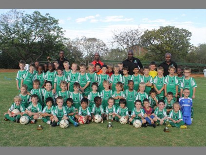 Mini soccer stars… Pro-Athletico Soccer School pupils and their coaches show off their fancy kit and awards.