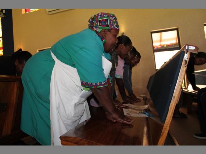 Practise makes perfect... Domestic workers used the church pews to get the 'chest compressions' right.
