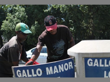 Dirty bins... Clean-up team empties the rubbish on Rivonia Road.