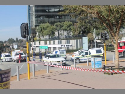 Sandton police keep people away as Ernst and Young, and Alexander Forbes buildings are searched for a potential bomb.