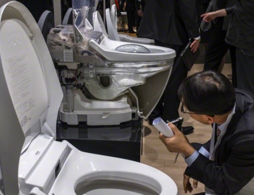 11 Mar 2015, Frankfurt, Rhineland, Germany --- A visitor inspects flush toilets on display at Grohe pavilion in ISH trade fair, in Frankfurt, Germany, 11 March 2015. The ISH is the world's leading trade fair that provides the world's biggest showcase for innovative bathroom design, energy efficient heating and air-conditioning technology and renewable energies, from 10 to 14 March 2015. --- Image by © Horacio Villalobos/Corbis