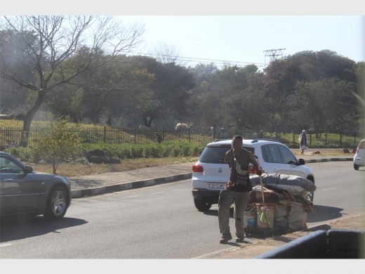 Displaced... A squatter, who wishes to remain anonymous, pulls along his belongings to a nearby church.