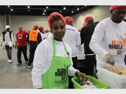 Charity... Mavis Vilakazi packs food at the Nelson Mandela Day initiative.