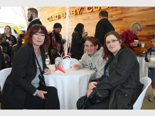 CLOSE UP: Emma Sayers, Sam Koenderman and Caitlin-Rose Sayers bond at the Christmas in July event.