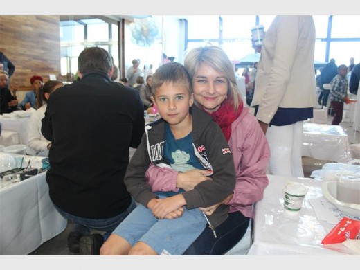 CUDDLES: Deborah with her son Michael Schepers at the Christmas in July event.