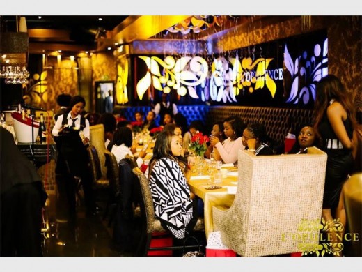 The women at the event enjoy champagne and tapas.