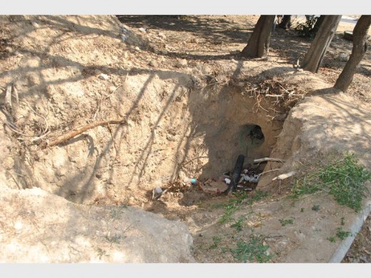A big hole with cables exposed.