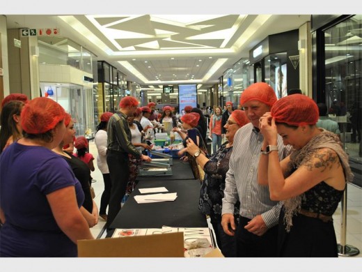 Volunteers help pack food at one of the stations.