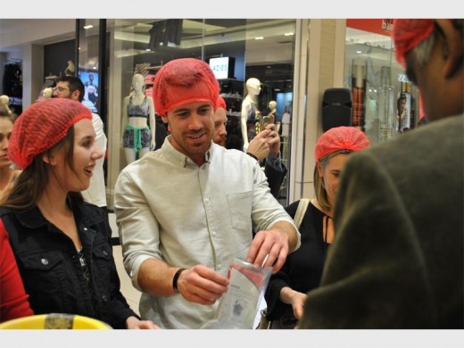 Brent Owens, 2014 MasterChef Australia winner, hard at work packing food.
