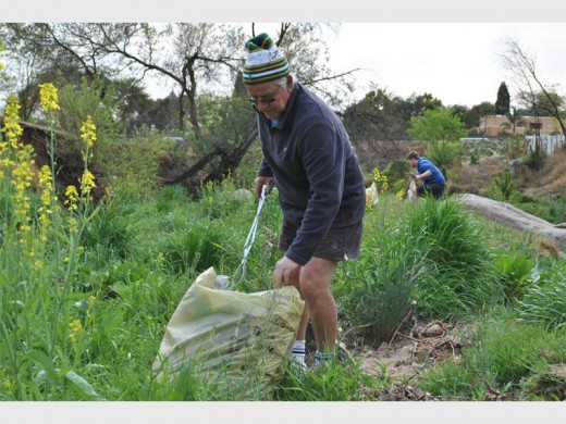 Albert Coleske does his part in cleaning up the riverbank.