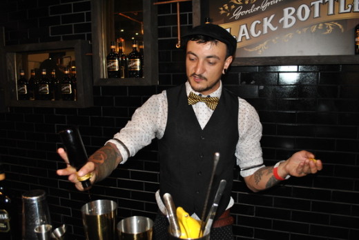 A bartender showing his skills in creating cocktails.