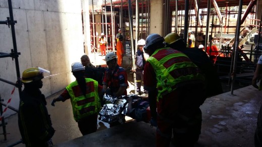 Patient injured in structural collapse is assisted by paramedics.