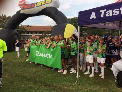 Beaulieu Preparatory School netball girls and cricket boys wait excitedly to run across the sports field to represent their school.